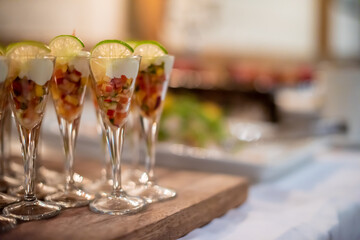 Obraz na płótnie Canvas Fruit coctails in glasses at a reception.