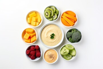 Flat lay of bowls with baby food and different fruits on white background