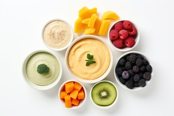 Flat lay of bowls with baby food and different fruits on white background