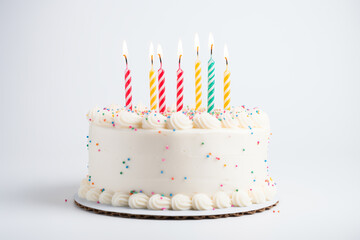 cake festive white with custard and seven burning candles on simple background
