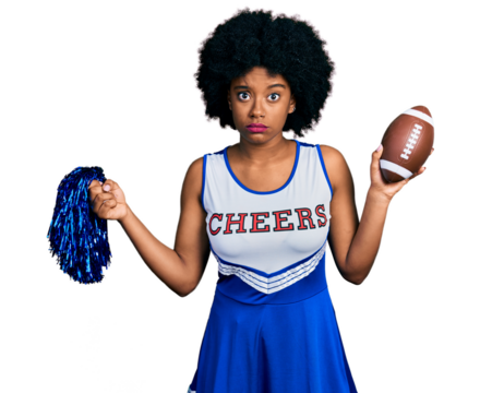 Young african american woman wearing cheerleader uniform holding pompom and football ball skeptic and nervous, frowning upset because of problem. negative person.