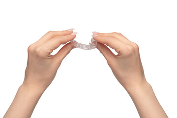 Transparent mouth guard in a woman's hand isolated.