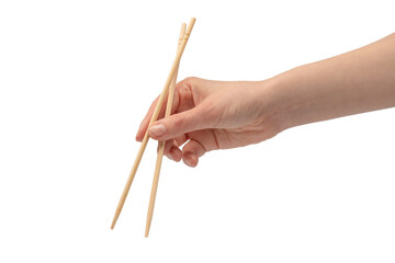 Female hand holding wooden sushi chopsticks isolated on white background.