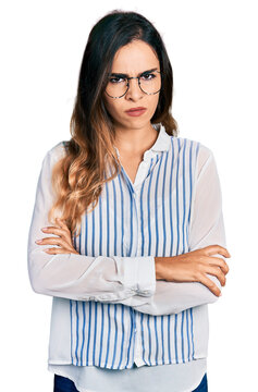 Beautiful hispanic woman wearing casual striped shirt skeptic and nervous, disapproving expression on face with crossed arms. negative person.