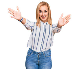 Beautiful caucasian woman wearing casual clothes looking at the camera smiling with open arms for hug. cheerful expression embracing happiness.