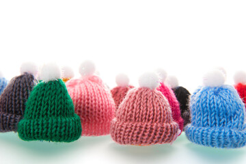 Colorful winter hats isolated over white background
