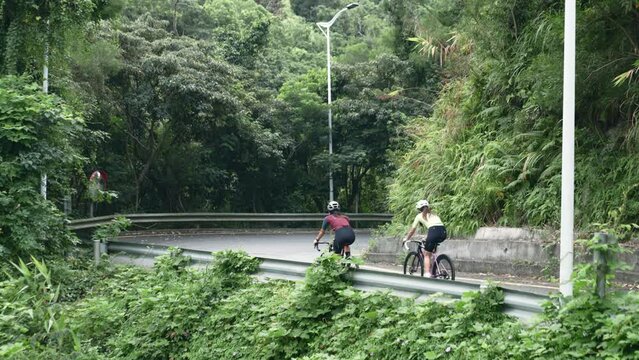 rear view of two female cyclists training on rural road