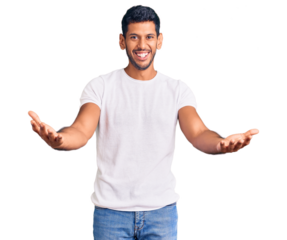 Young latin man wearing casual clothes smiling cheerful offering hands giving assistance and acceptance.