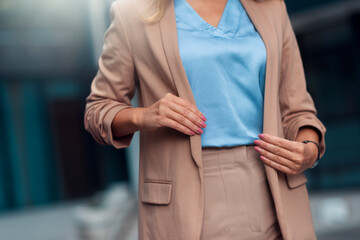 Business woman holding her suit outdoors