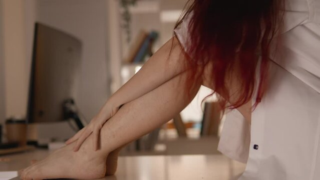 Sexy horny woman sitting on table in guest room A girl is waiting for her boyfriend and future sex with him. Erotic fantasies of a man