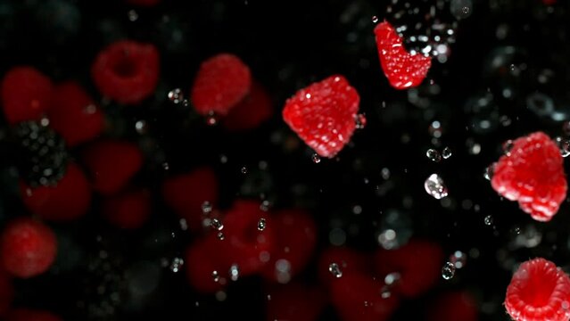 Super Slow Motion of Berries Mix Isolated on Black Background. Filmed on High Speed Cinema Camera, 1000 fps. Speed Ramp Effect.