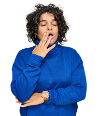 Young hispanic woman with curly hair wearing turtleneck sweater bored yawning tired covering mouth...