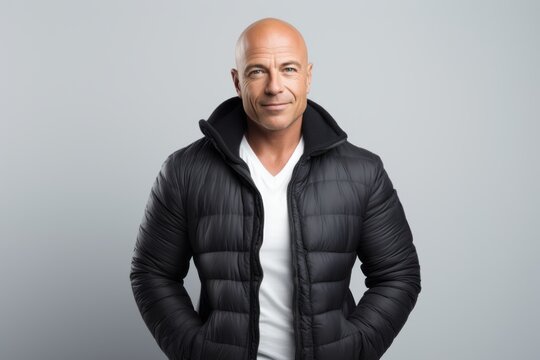 Portrait of a confident mature bald man in a black jacket.