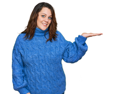 Young plus size woman wearing casual clothes smiling cheerful presenting and pointing with palm of hand looking at the camera.