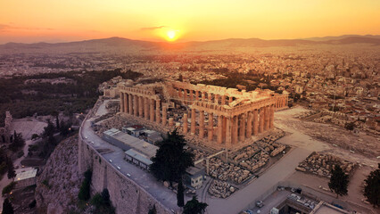 Aerial drone photo of iconic Acropolis hill and the unique masterpiece of Ancient world the Parthenon at sunset with beautiful golden colours, Athens historic centre, Attica, Greece