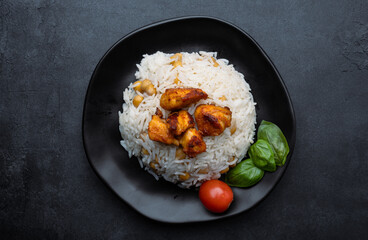 Chicken pieces on rice with chickpeas