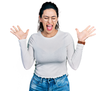 Young hispanic woman wearing casual clothes celebrating mad and crazy for success with arms raised and closed eyes screaming excited. winner concept