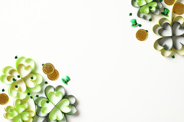 Paper craft four leaf clover, gold coins, confetti on white table. St Patricks Day banner.