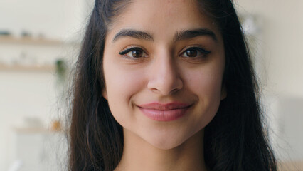 Close up face woman multiethnic indian arabian homeowner businesswoman student girl with healthy smooth skin natural beauty make-up charming portrait joyful lady smiling female head shot in kitchen