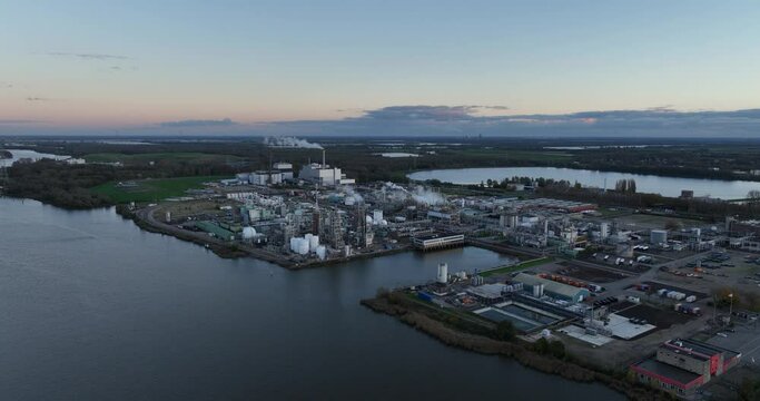 The manufacturing process, materials, sustainability, and innovation in a factory specializing in synthetic polymers and plastics. Birds eye aerial drone view. Dordrecht, The Netherlands.