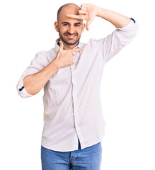 Young handsome man wearing elegant shirt smiling making frame with hands and fingers with happy face. creativity and photography concept.