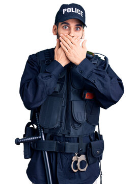 Young handsome man with beard wearing police uniform shocked covering mouth with hands for mistake. secret concept.