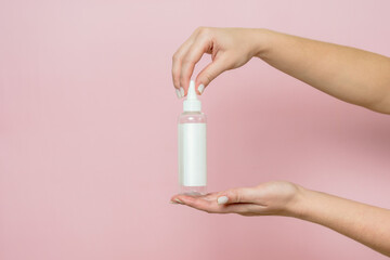 Cosmetic bottle in woman's hand. Cosmetic product branding mockup. Daily skincare and body care routine.