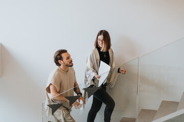 Focused employees collaborating in a modern office, finding project solutions and achieving...