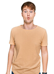 Young caucasian man wearing casual clothes making fish face with lips, crazy and comical gesture. funny expression.