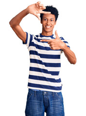 Young african american man wearing casual clothes smiling making frame with hands and fingers with happy face. creativity and photography concept.