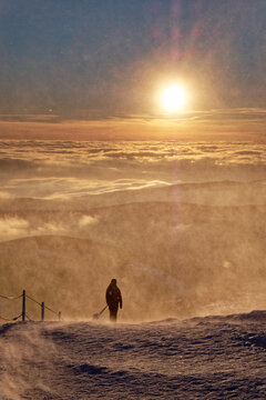 Lonely person during sunrise in the mountains.