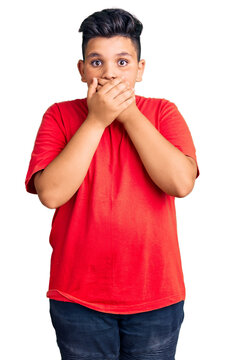 Little boy kid wearing casual clothes shocked covering mouth with hands for mistake. secret concept.