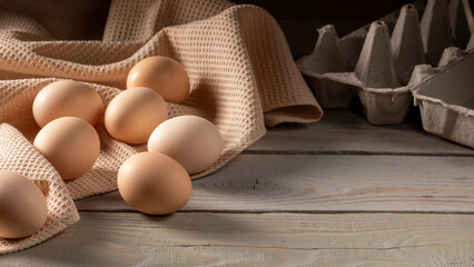 Close-up of fresh chicken eggs on rustic wooden peasant table