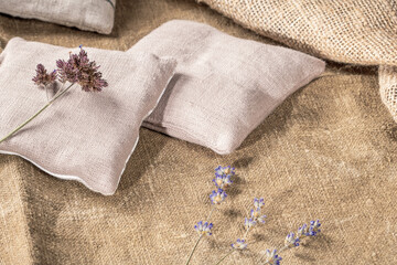 Country style decor with peasant pillows and dried lavender stems on burlap