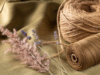 Serene and cozy setting with dried flower stalks and burlap as background