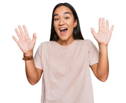 Young asian woman wearing casual clothes showing and pointing up with fingers number ten while smiling confident and happy.