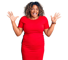 Young african american plus size woman wearing casual clothes celebrating victory with happy smile and winner expression with raised hands