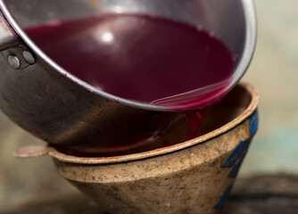 Wine making. Fresh grape juice is poured through a funnel into a barrel. Harvest home. Technology of wine production in Moldova.