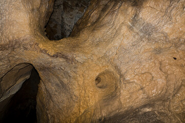 Speleology. The Bacho Kiro cave, Dryanovo, Bulgaria. Stalactite, and stalagmite speleothem formations.