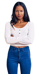 Young indian girl wearing casual clothes skeptic and nervous, disapproving expression on face with crossed arms. negative person.