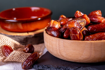 dried dates in a wood pot and empty pot