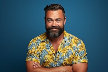 Portrait of a handsome man with a beard and mustache over blue background