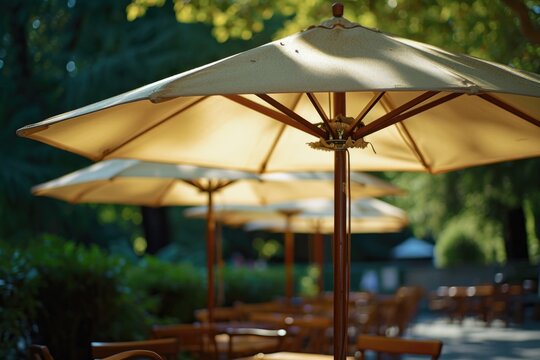 A row of tables with colorful umbrellas set up for outdoor seating on a bright and sunny day. Perfect for illustrating outdoor dining, leisure activities, and summer vibes