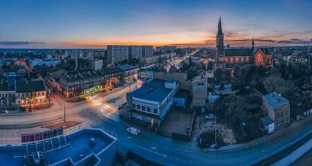 View at Pabianice city and Church of Our Lady of the Rosary from a drone at sunset - obrazy, fototapety, plakaty