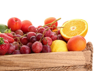 Wooden box with different fresh fruits on white background