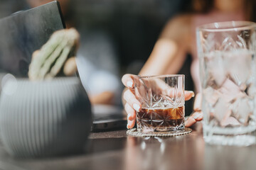 Business partners celebrating success at the restaurant, drinking whiskey and cheering.