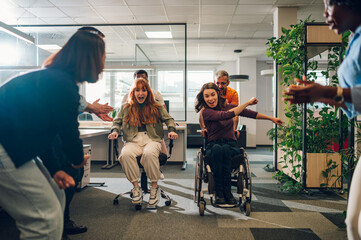 Woman who uses a wheelchair is winning the office chair race with her colleagues