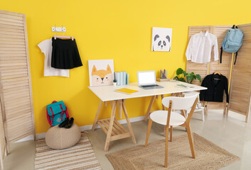Interior of modern room with workplace and stylish school uniform