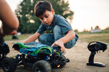 Boy putting back the shell on a remote controlled race car toy