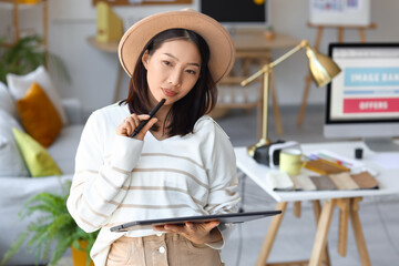 Asian interior designer working with graphic tablet in office